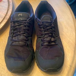 Gently used women’s size 10.5 solid black On cloud running shoes.